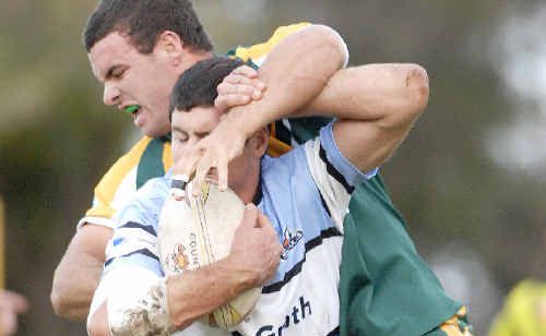 Ballina Seagulls forward Robbie Miles tries to ward off a tackle from a Cudgen defender yesterday. Ballina Seagulls forward Robbie Miles tries to ward off a tackle from a Cudgen defender yesterday.